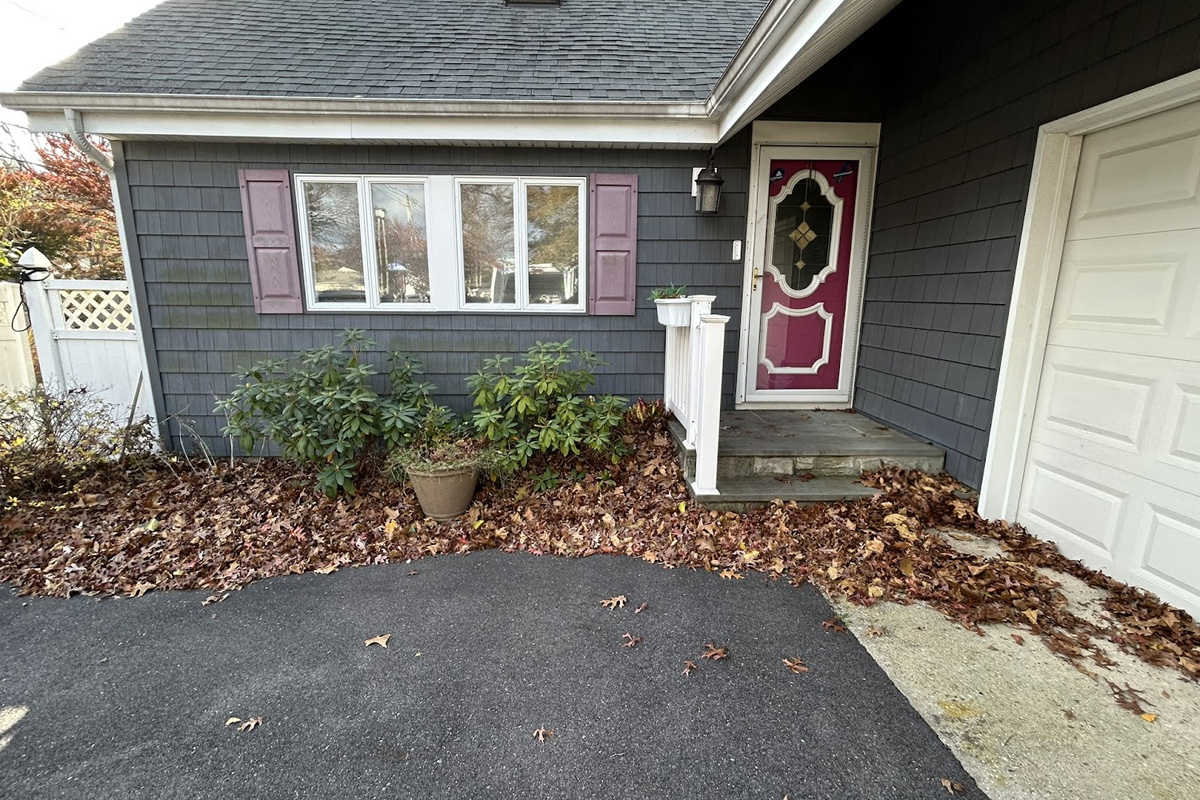 Freshly washed grey home exterior and driveway as part of exterior cleaning services in Long Island.